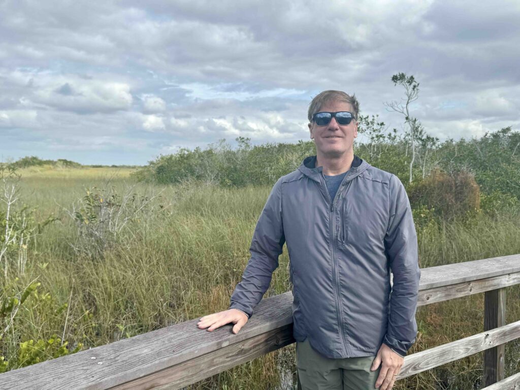 man on a boardwalk in the Everglades