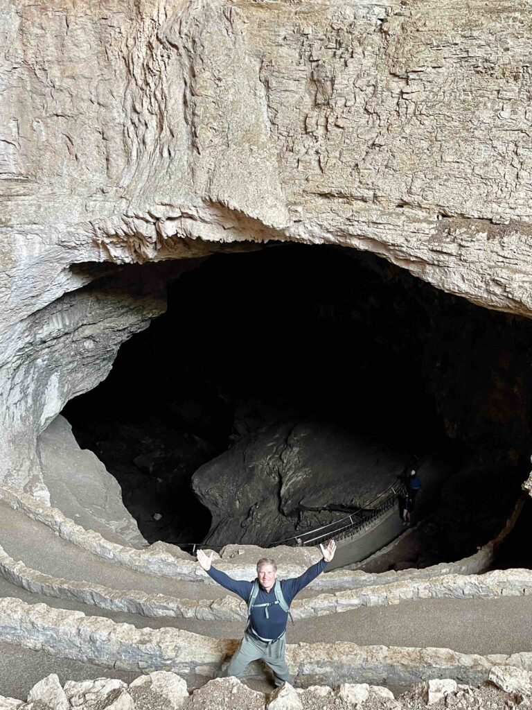 two pictures of the main entrance to the caves; one with a man in front of the cave