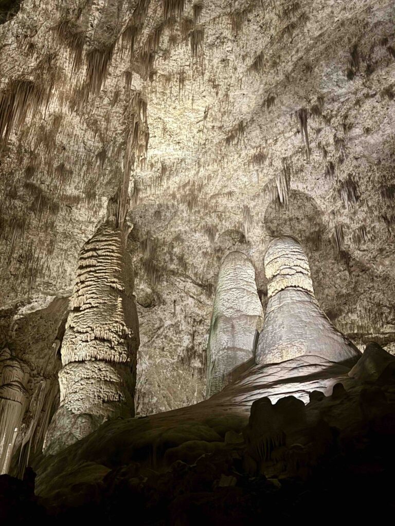 large Stalagmite and Stalactites in a dark cave